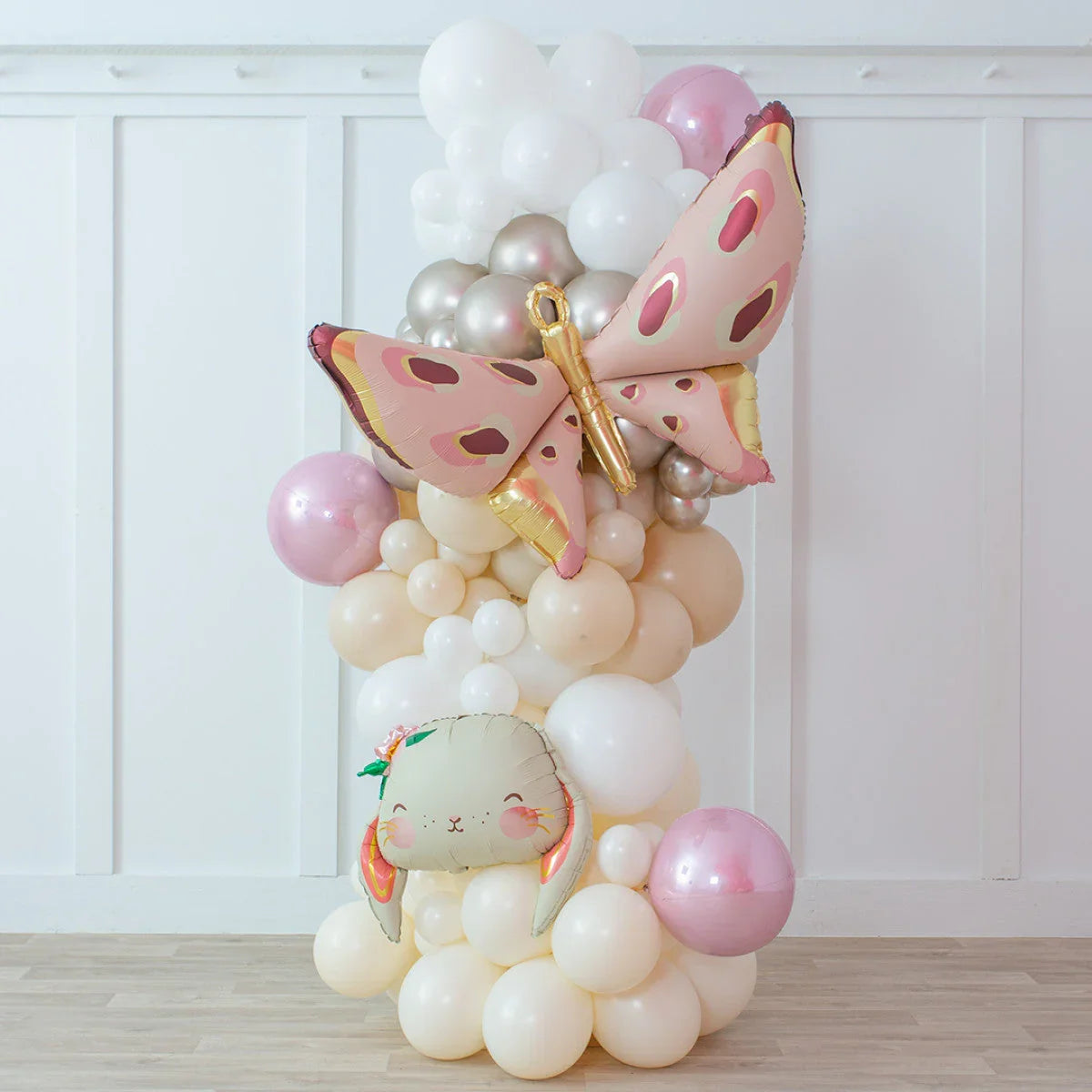 Easter balloon pillar with cream, white, metallic, pink balloons, large butterfly and bunny face balloons