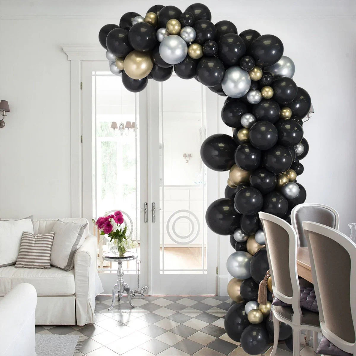 Black, gold, and silver balloon arch in modern Dubai living room event decor