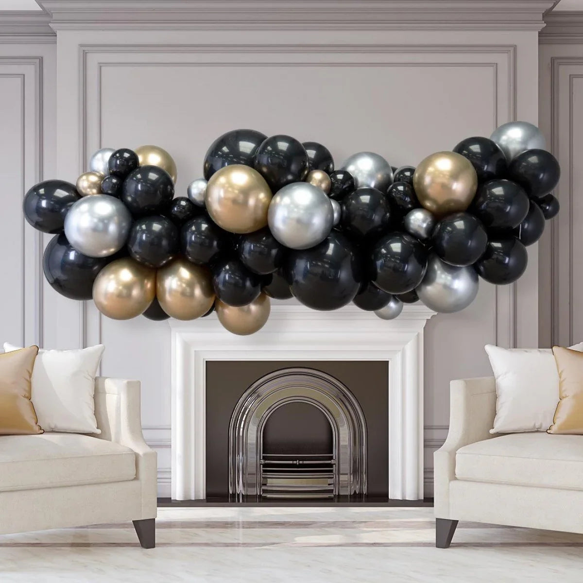 Black, gold, and silver balloon garland decoration over white fireplace in elegant living room