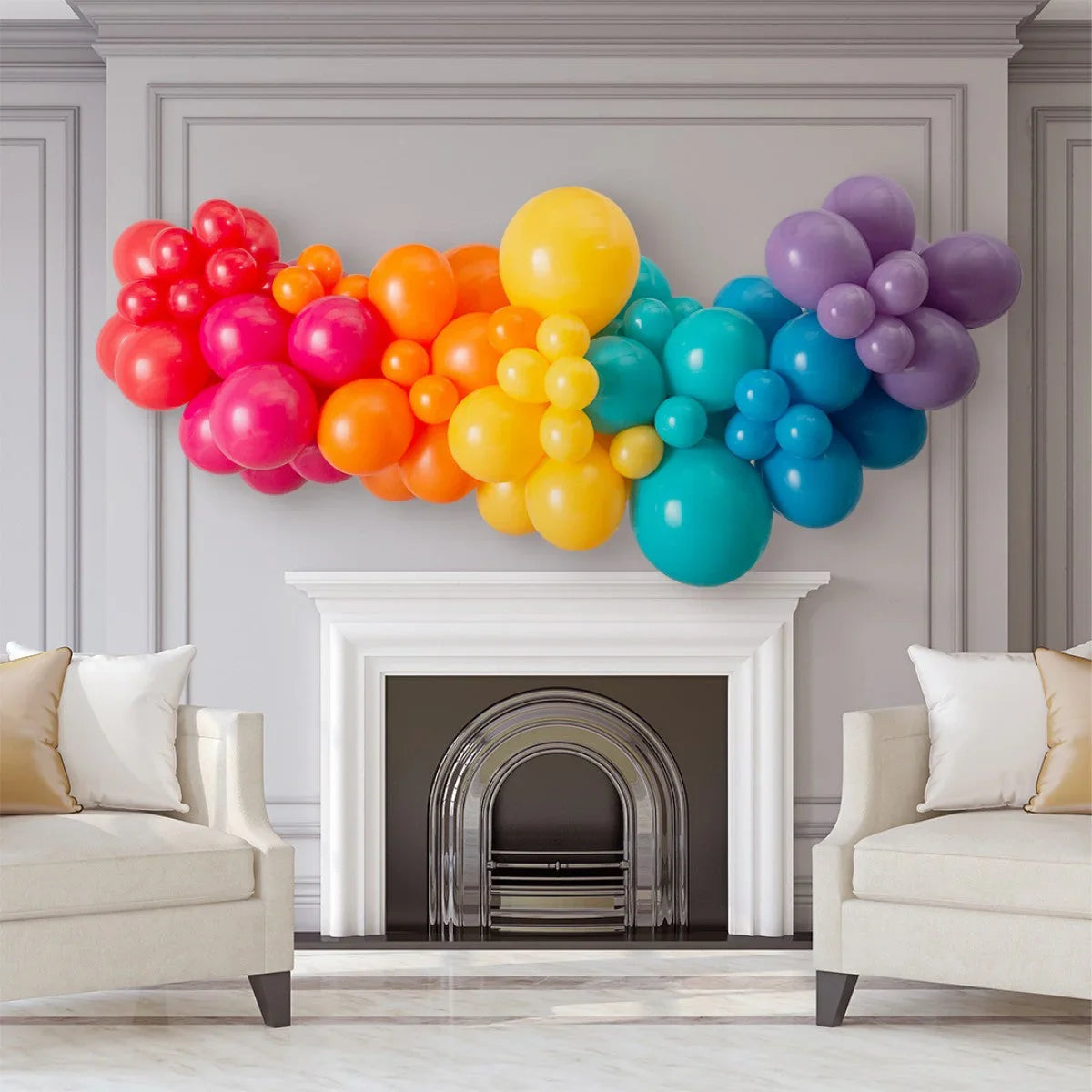 Rainbow balloon garland decoration above white fireplace in elegant living room with beige sofas