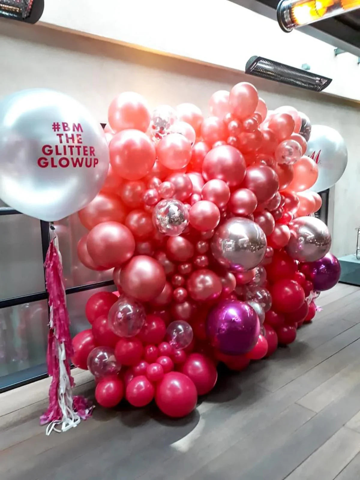 Pink and red balloon wall decoration with large white balloons branded #BM The Glitter Glowup indoors