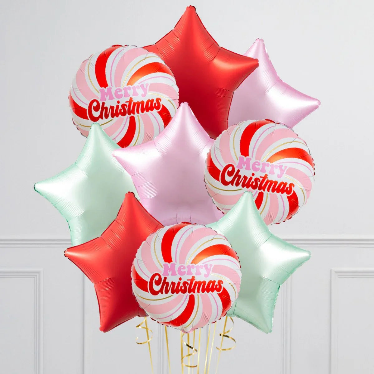 Christmas balloons bouquet with red, pink, mint star-shaped and candy cane swirl Merry Christmas foil balloons