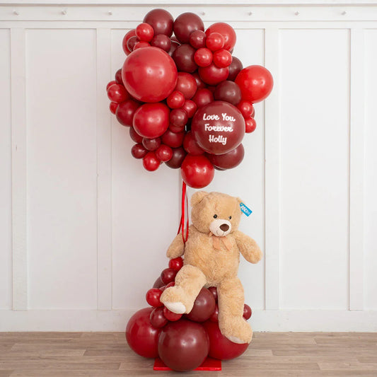 Dark cherry and red hot balloon arrangement with teddy bear gift, indoor decor