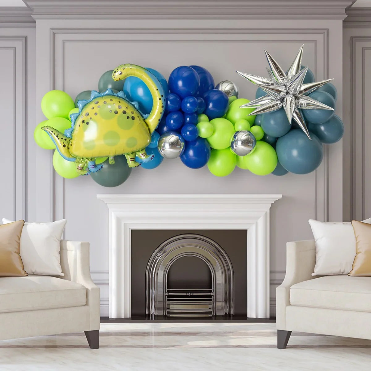Dinosaur themed balloon garland with green, blue, silver balloons and foil dinosaur above white fireplace