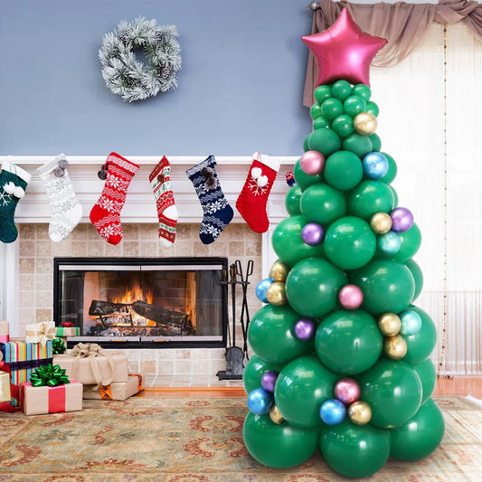 Festive green balloon Christmas tree with star topper near fireplace, stockings, and gifts