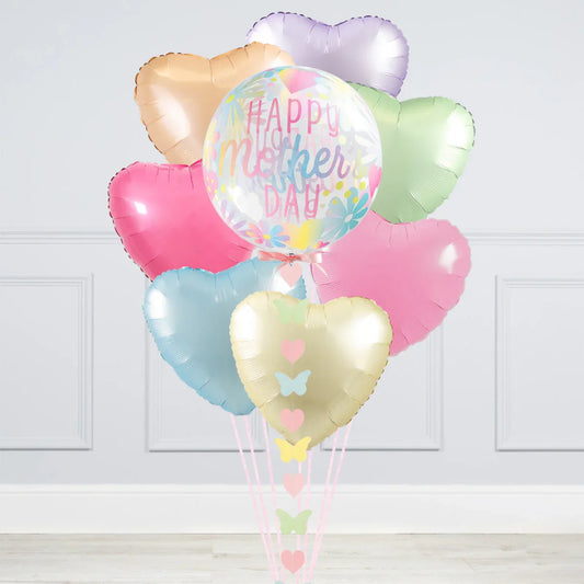 Pastel heart balloons with 'Happy Mother's Day' bubble balloon in a white room