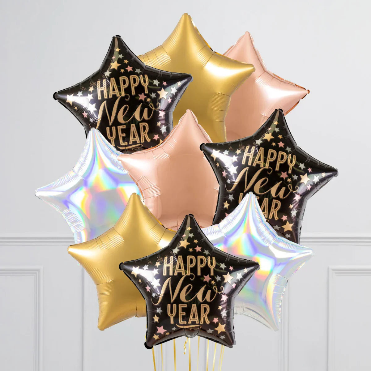 Star-shaped Happy New Year foil balloons in black, gold, rose gold, and holographic silver