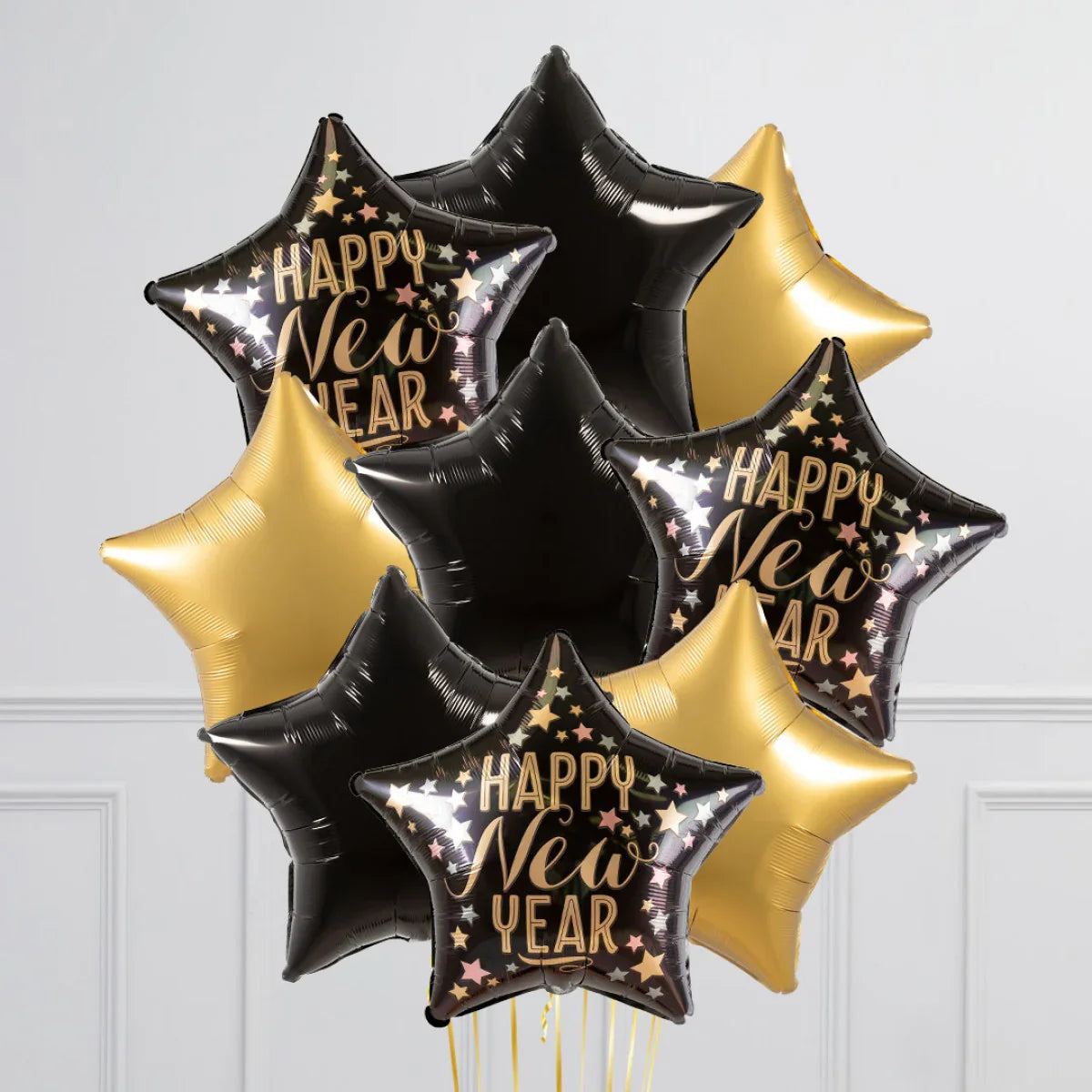 Star-shaped black and gold foil balloons with Happy New Year text and stars decoration
