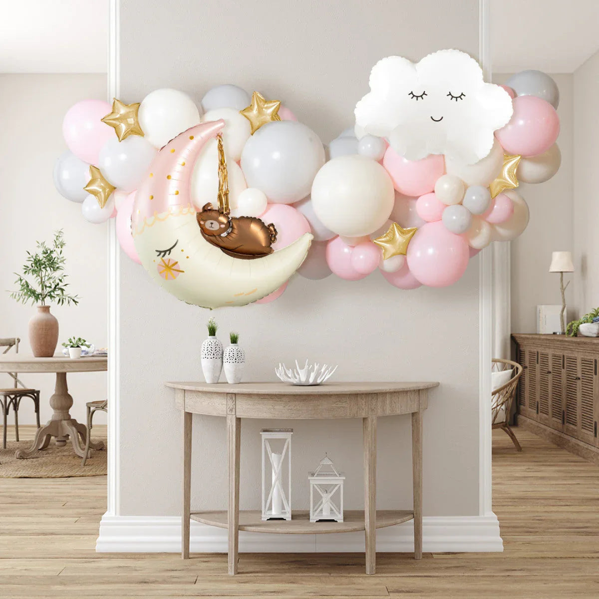 Pink, white, and gold balloon garland with moon, bear, cloud shapes in modern home party decor
