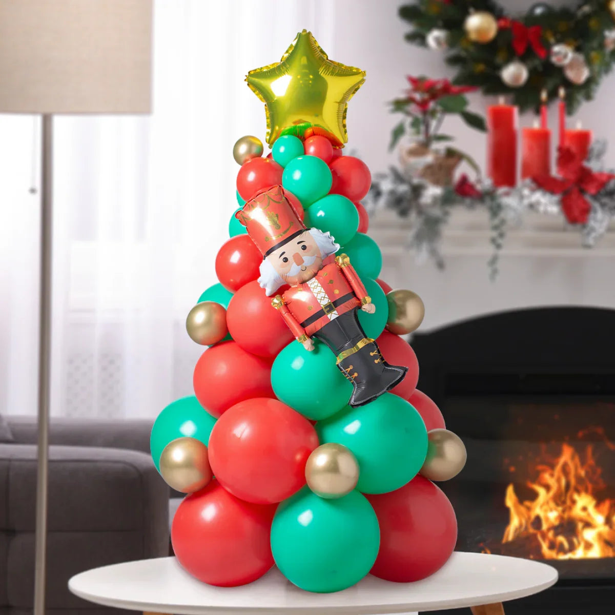 Mini Christmas tree balloon stack with red, green, and gold balloons topped with a gold star and nutcracker figure