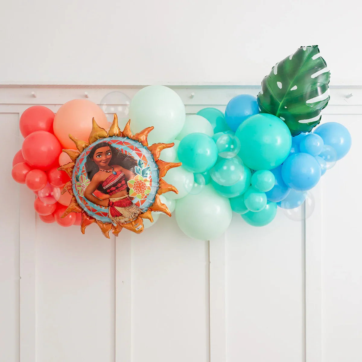 Colorful Moana party balloon garland with blue, green, orange balloons and tropical leaf foil balloon