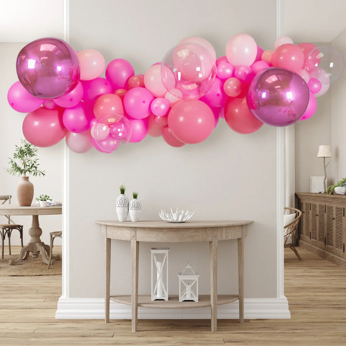 Pink and transparent balloon garland decoration above wooden console table in modern living room