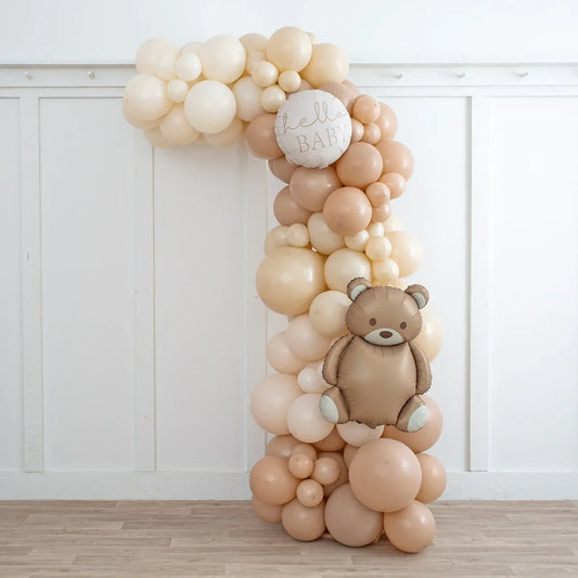 Neutral beige balloon arch with teddy bear and Hello Baby sign for baby shower decor