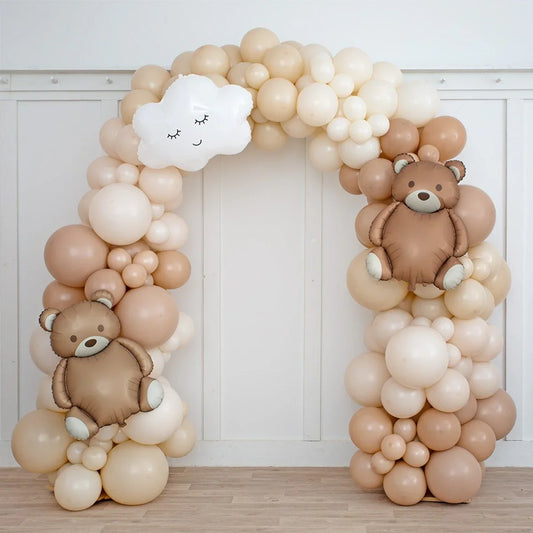 Neutral beige balloon arch with teddy bear and cloud balloons, indoor party decor Dubai