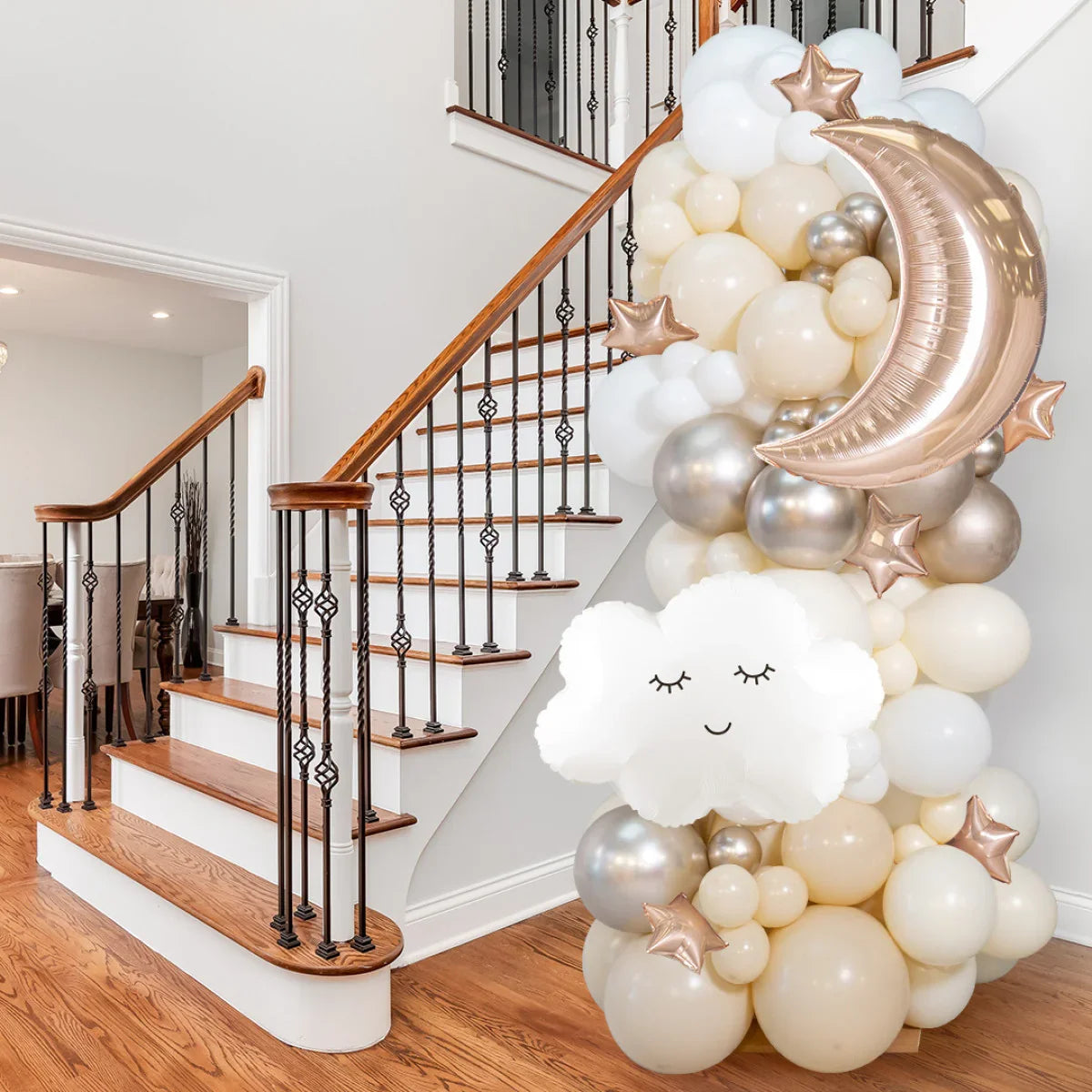 Neutral balloon pillar decoration with white cloud, rose gold crescent moon and stars near staircase