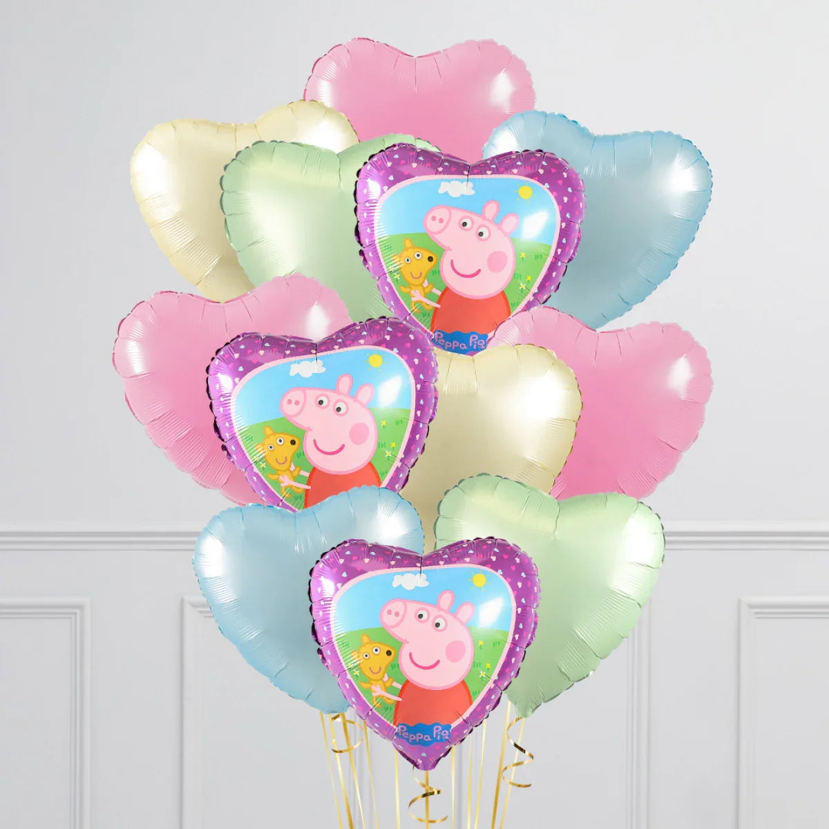 Bunch of heart-shaped foil balloons with pastel colors and Peppa Pig design for kids parties
