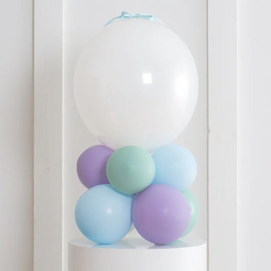 Personalized large white balloon with pastel purple, blue, and green balloons base on white pedestal