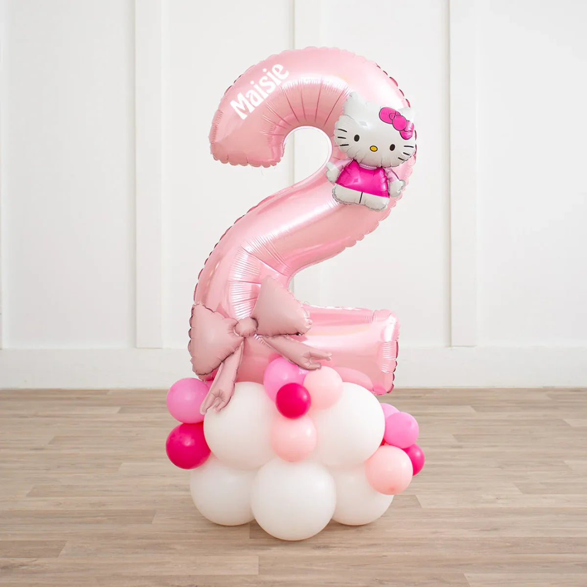 Personalized pink Hello Kitty number 2 balloon with bow, standing on cluster of white and pink balloons