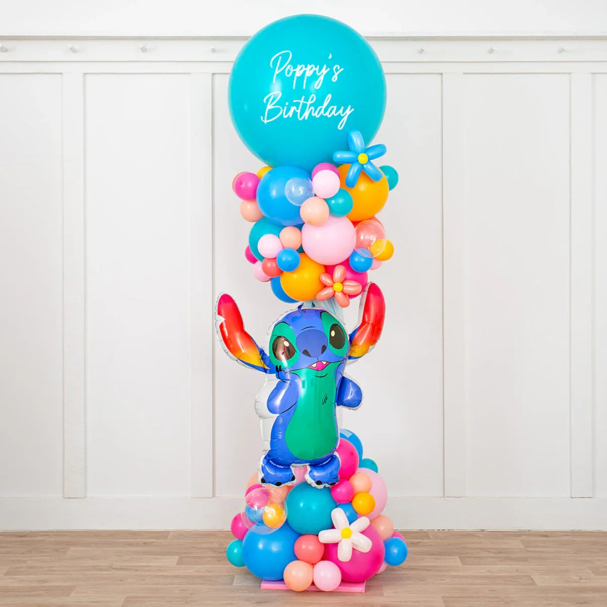 Colorful birthday balloon arrangement with a stitch character and Poppy's Birthday text