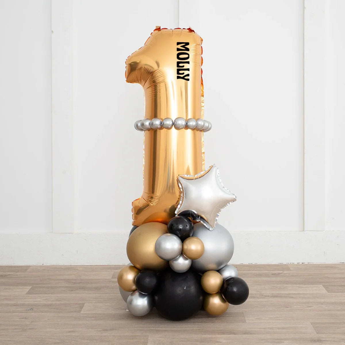 Gold metallic number 1 balloon with name Molly, silver star and black, gold, silver balloon cluster