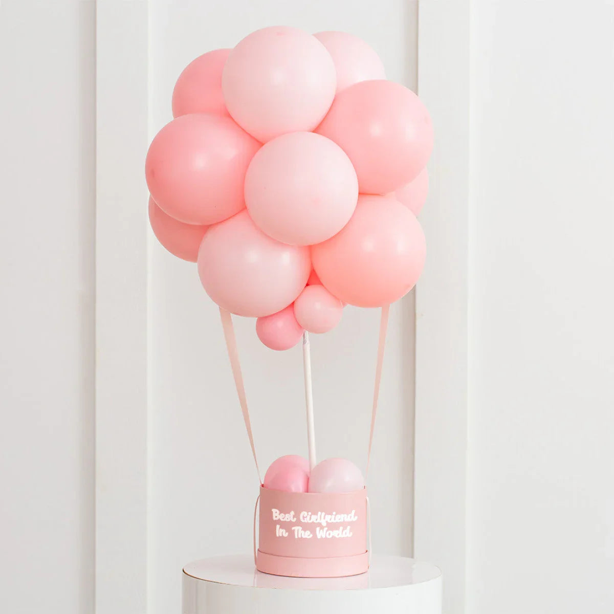 Pink latex balloon hot air balloon decoration in white room with 'Best Girlfriend In The World' text