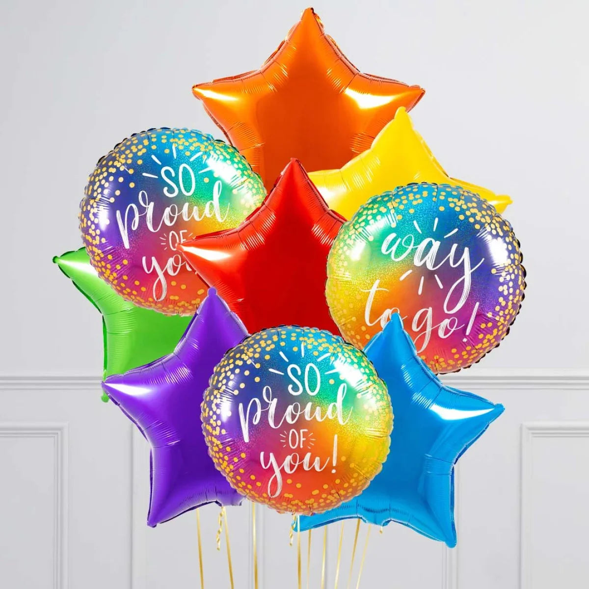 Colorful inflated foil balloons with star shapes and rainbow round balloons saying So Proud of You and Way to Go