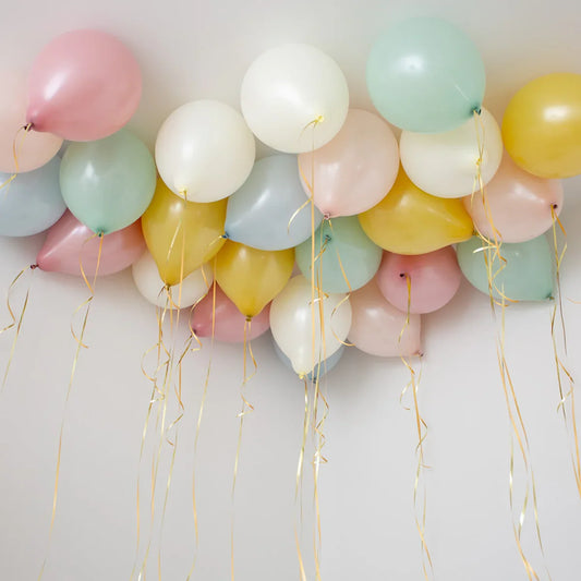 Retro pastel helium balloons with ribbons on a ceiling, party decor in Dubai