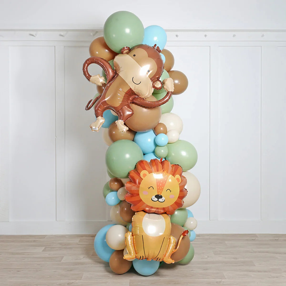 Safari cubs balloon pillar with monkey and lion foil balloons in pastel party decor