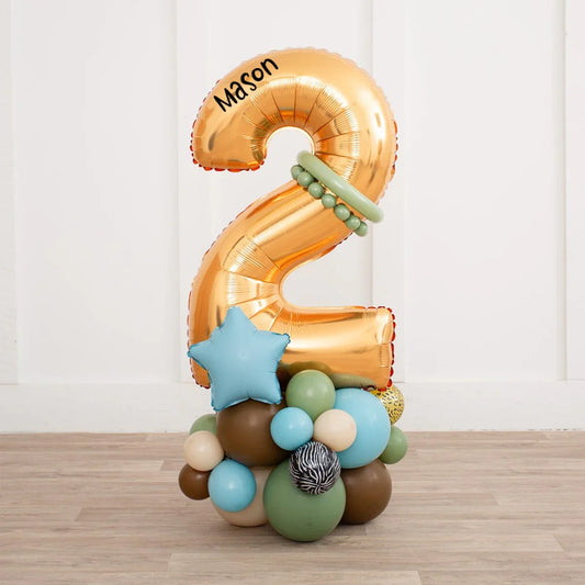 Gold number 2 balloon bouquet with jungle-themed and animal print balloons for birthday party