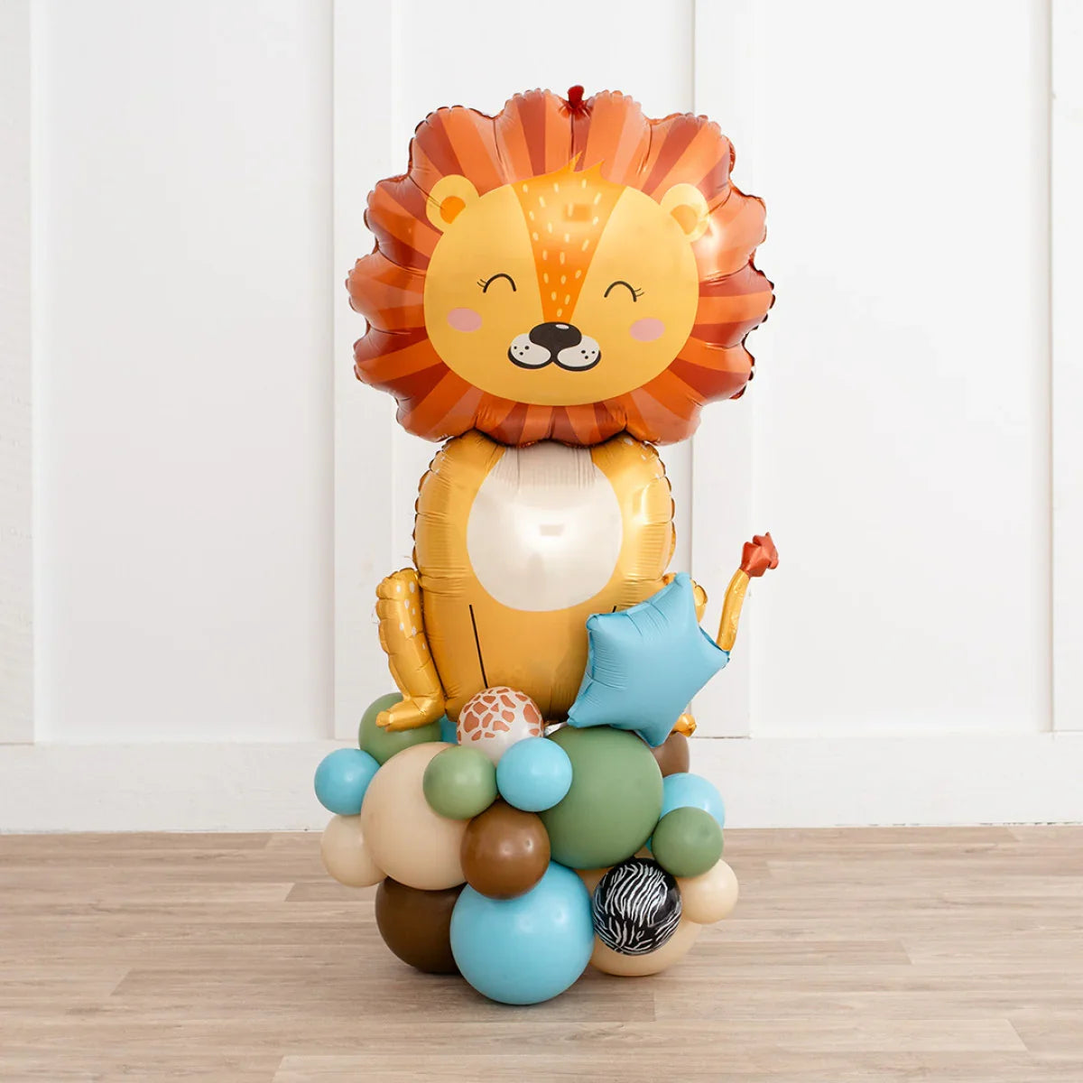 Safari-themed balloon arrangement with a large lion foil balloon and colorful round balloons