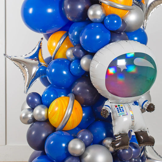 Space party balloon arch with astronaut, planets, and blue, silver, and star balloons