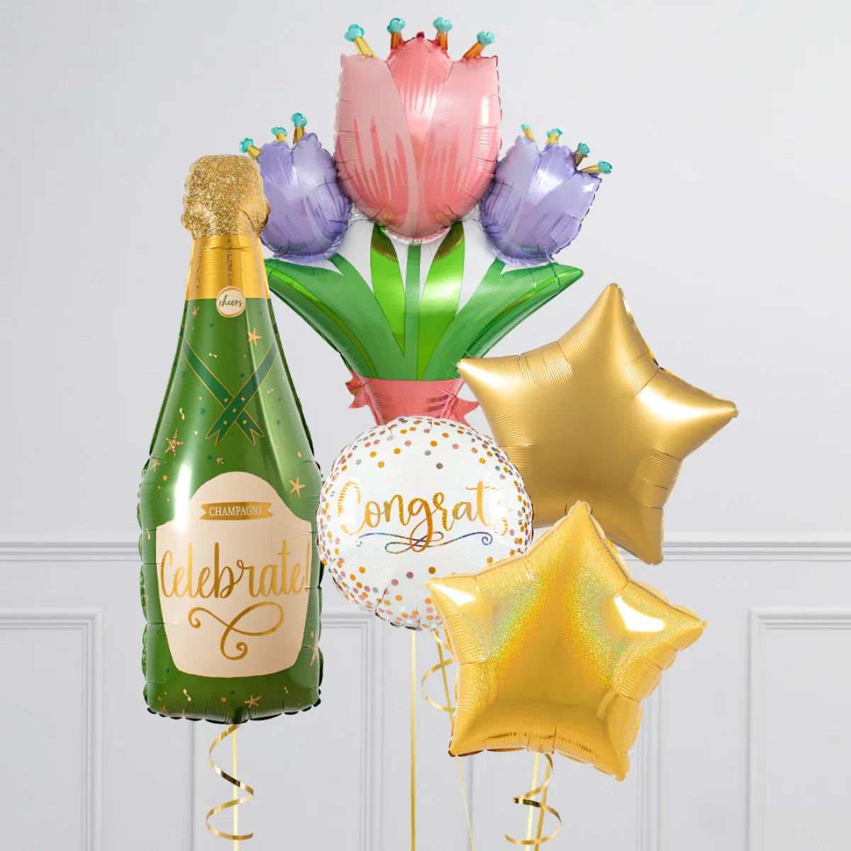 Festive foil balloons including champagne bottle, tulip bouquet, gold stars, and congratulatory round balloon