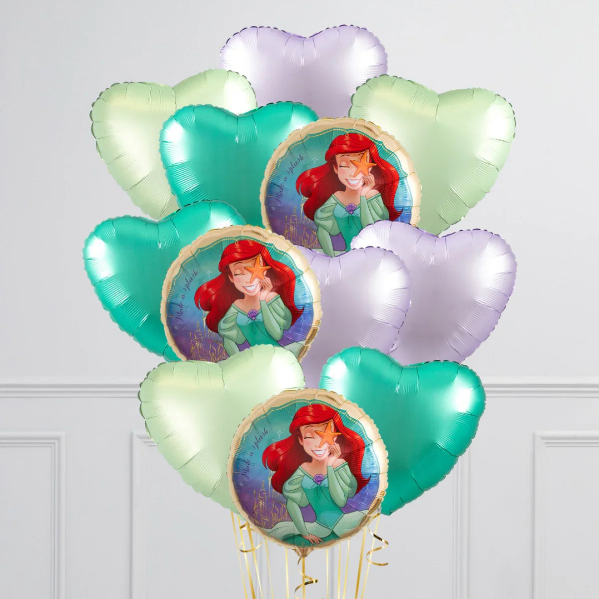 Bunch of metallic heart-shaped balloons in green, purple, and teal with The Little Mermaid Ariel foil balloons featuring red hair and starfish
