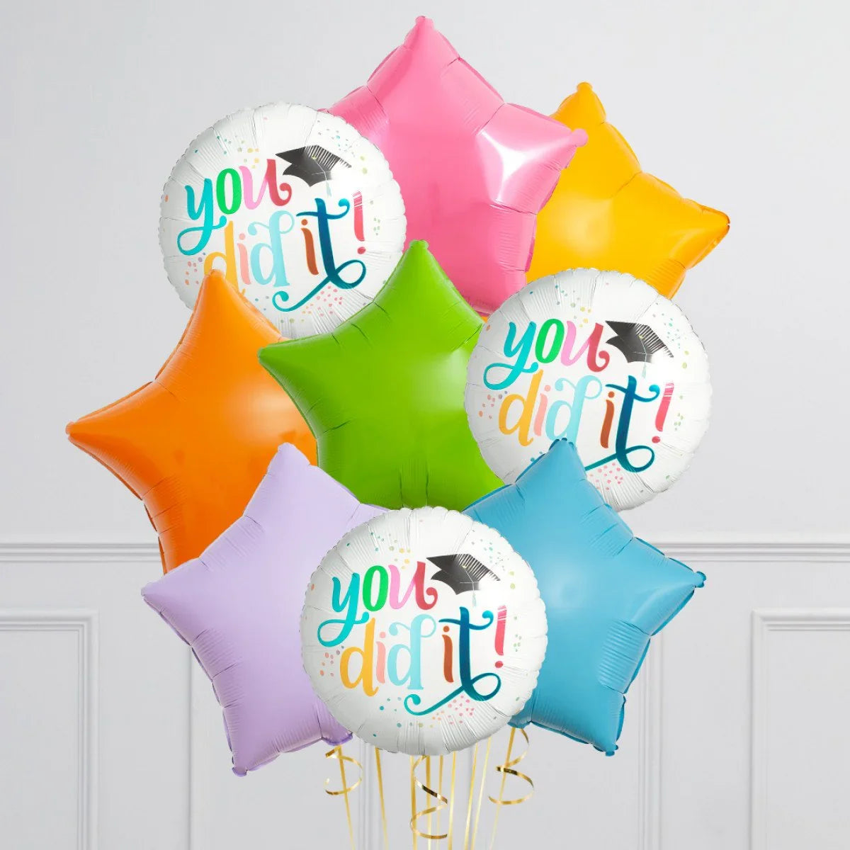 Colorful star-shaped and round foil balloons with 'You did it!' graduation message