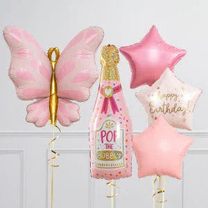 Pink butterfly and champagne bottle foil balloons with pink and gold star balloons, one saying happy birthday.