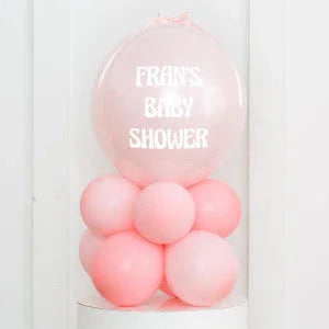 Pink baby shower balloon arrangement with 'Fran's Baby Shower' text in white