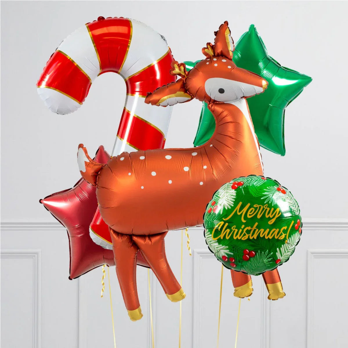 Christmas balloon arrangement with a woodland reindeer, candy cane, green and red stars, and Merry Christmas balloon