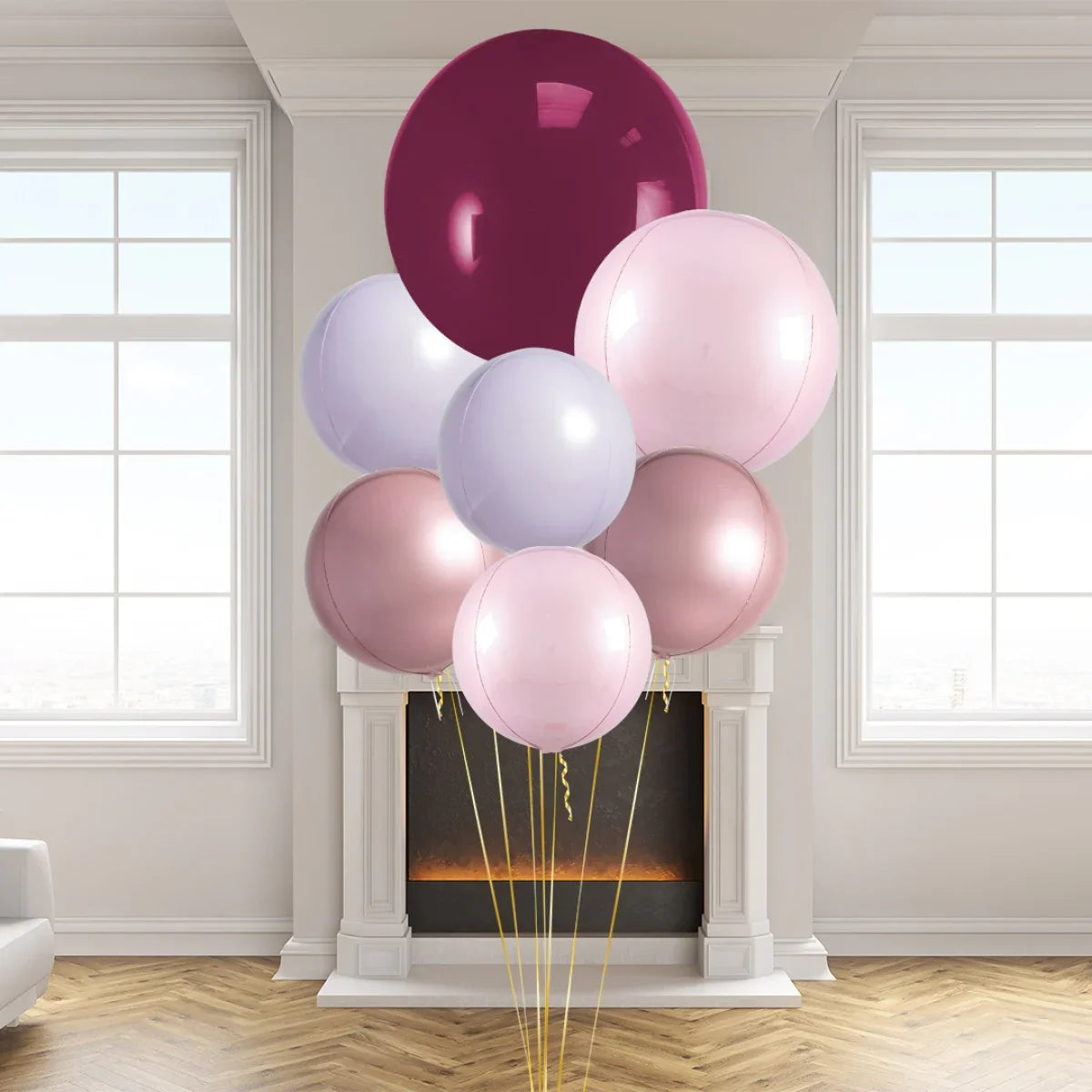 Cluster of glossy pink, rose gold, lilac, and mulberry balloons in elegant living room with fireplace and large windows