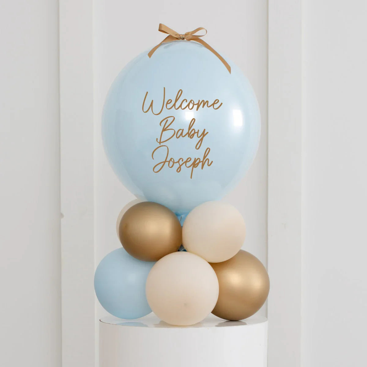 Personalised baby blue and gold welcome balloon stack for baby shower in Dubai