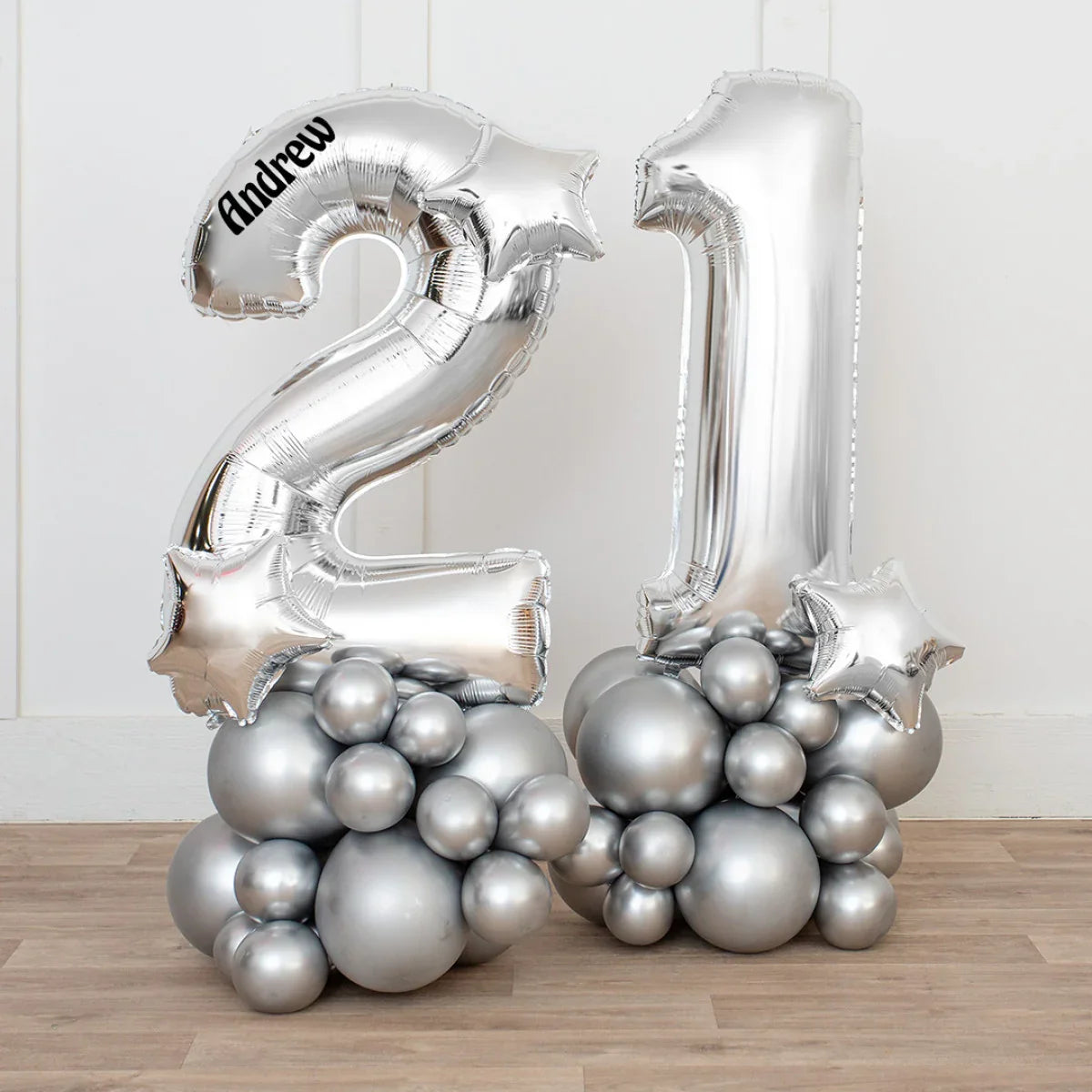 Silver chrome number 21 balloons with stars and base of clustered silver balloons, personalized with Andrew