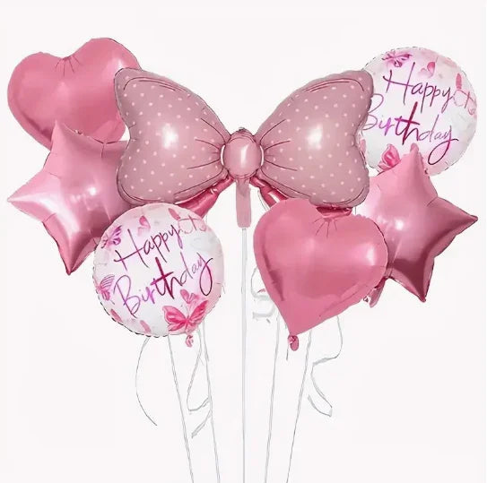 Pink birthday balloons including a large polka-dot bow, hearts, stars, and Happy Birthday print