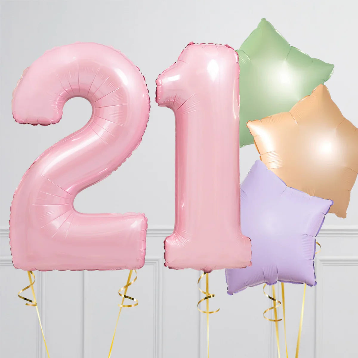 Pink number 21 balloons with green, orange, and purple star-shaped balloons on gray background