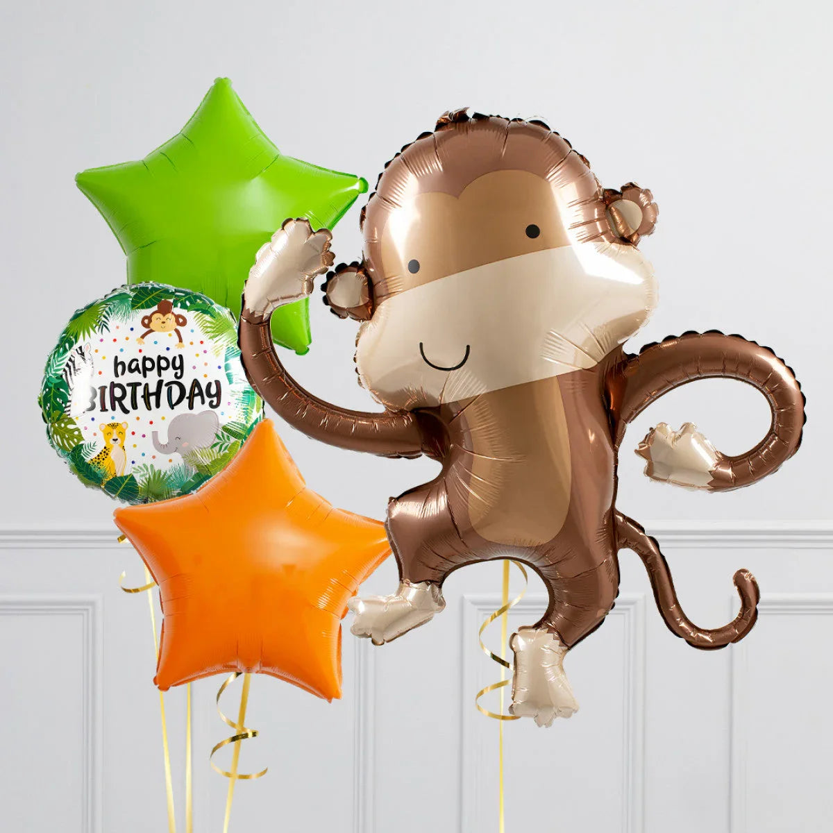 Birthday balloons set with a large monkey foil balloon, green and orange star balloons, and a jungle-themed happy birthday balloon