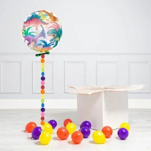 Dinosaur balloon with colorful string, scattered red, yellow, purple balloons, open box