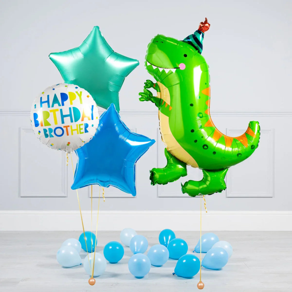 Birthday balloons including a green dinosaur with party hat and star-shaped blue and teal balloons
