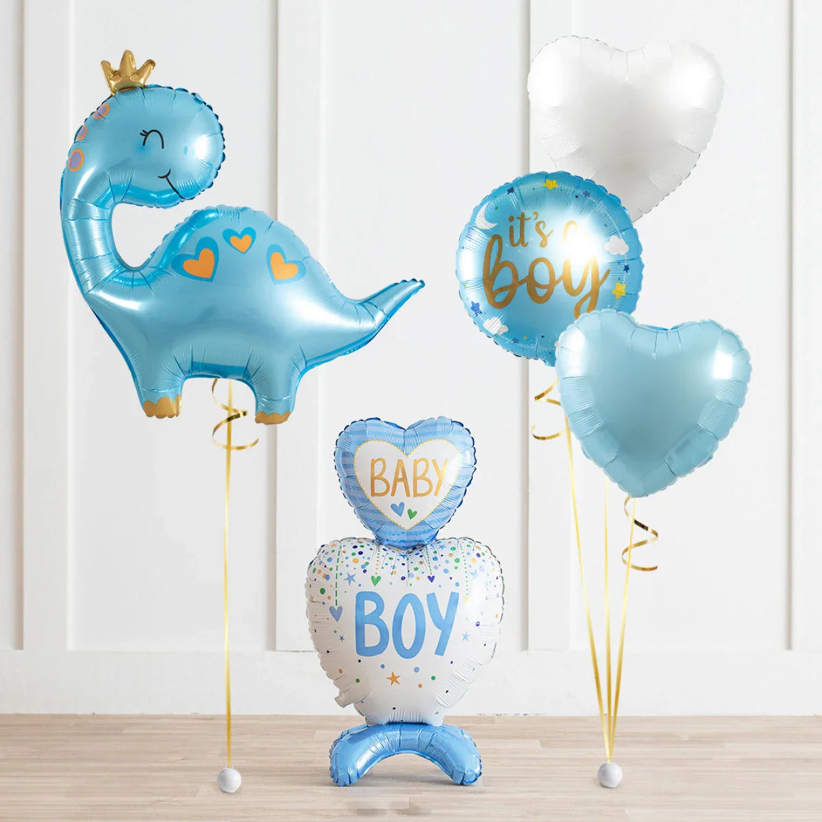 Blue dinosaur and heart-shaped baby shower balloons with 'It's a Boy' and 'Baby Boy' text