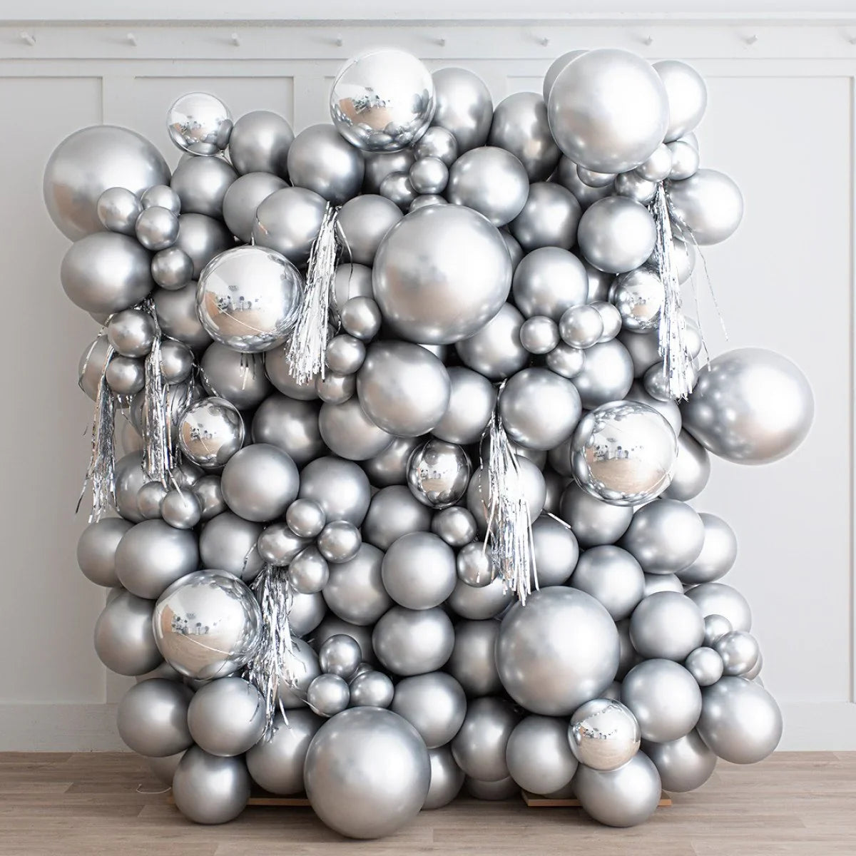 Silver chrome balloon backdrop with metallic balloons and tassels for party decoration