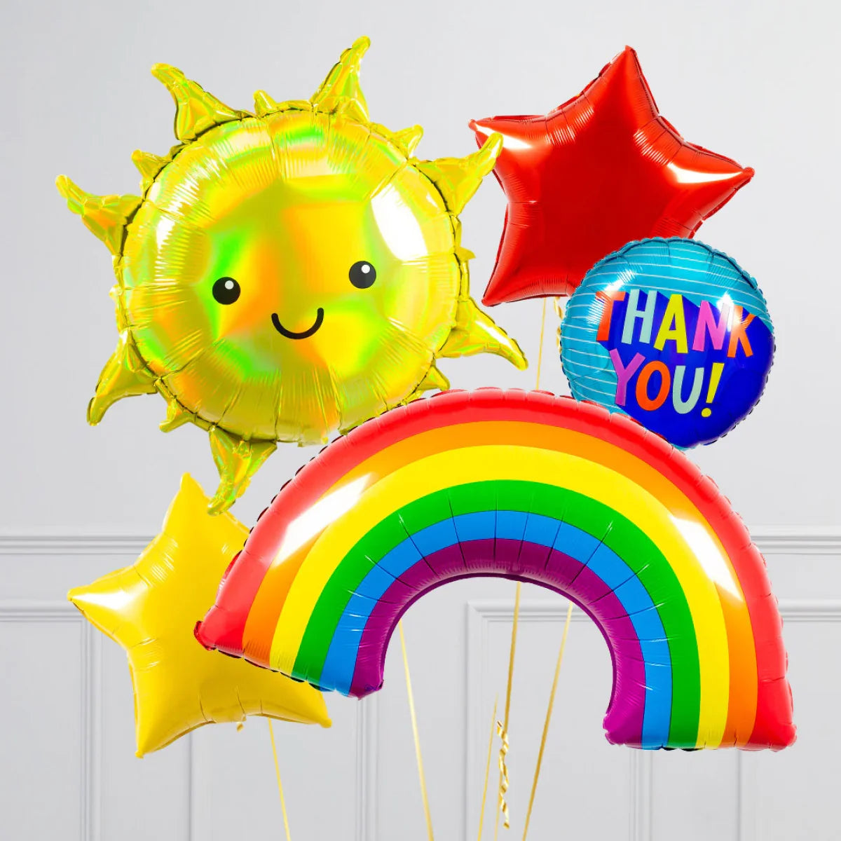 Colorful foil balloons including smiling sun, rainbow, red and yellow stars, and blue thank you balloon