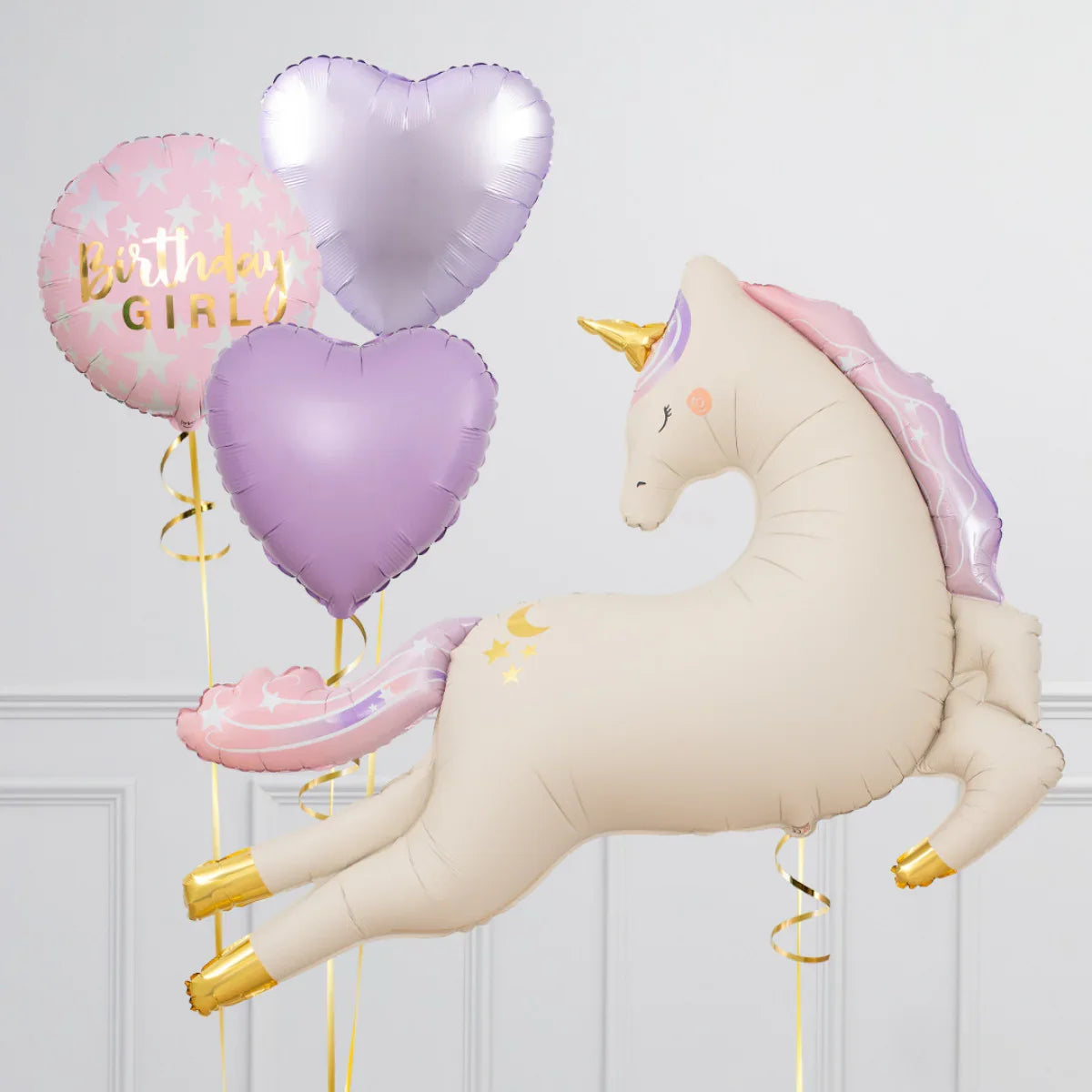 Inflatable unicorn balloon with gold hooves and pastel mane, alongside pink birthday girl and purple heart balloons
