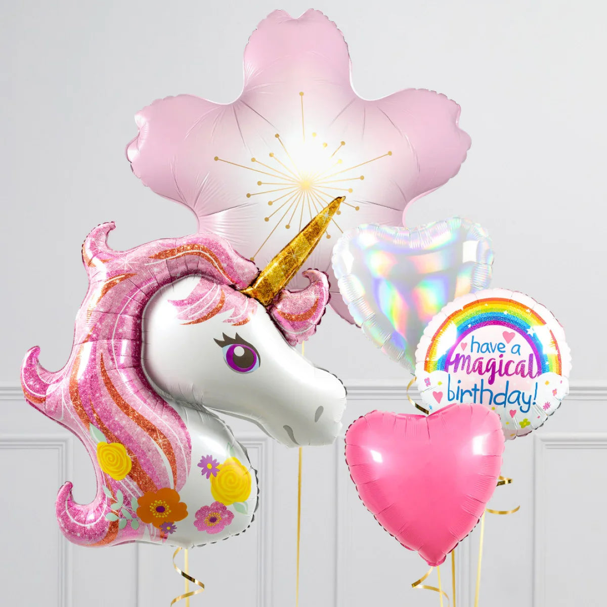 Unicorn birthday balloons set with pink mane, gold horn, heart shapes, and have a magical birthday message